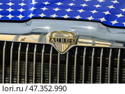Saint Petersburg, Russia - June 8 2024, Close-up view of the emblem, hood and radiator of the luxury car Aurus, St Petersburg, Russia. Редакционное фото, фотограф Сергей Богомяко / Фотобанк Лори