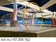 Pattaya, Thailand - December 05, 2018: Water springle splash colorful ring tunnel pool in the Ambassador City Jomtien hotel. Редакционное фото, фотограф Игорь Дашко / Фотобанк Лори