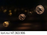 Abu Dhabi, United Arab Emirates - Jan 17 2024, Close-up view of the ancient antique coins in the Louvre Abu Dhabi Museum, belonging to different eras, Abu Dhabi, United Arab Emirates. Редакционное фото, фотограф Сергей Богомяко / Фотобанк Лори