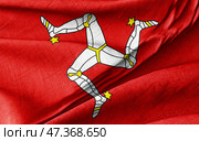 Isle of Man Flag Featuring the Triskelion Symbol on Wavy Red Fabric. Стоковое фото, фотограф Kirill Tonkikh / Фотобанк Лори