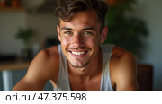 Bright Smile and Vibrant Energy From a Young Man Enjoying a Sunlit Moment in a Cozy Indoor Space. Стоковое AI-изображение, AI-художник Sergey Grishin / Фотобанк Лори