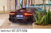 Doha, Qatar - Jan 06 2024, a close up view of super car Lamborghini, which is parked on the street in Msheireb district, at nighttime, Doha, Qatar. Редакционное фото, фотограф Сергей Богомяко / Фотобанк Лори