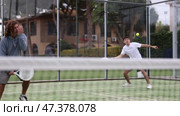 Caucasian man playing paddle tennis on the padel court. Стоковое видео, видеограф Яков Филимонов / Фотобанк Лори