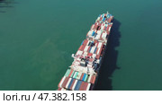 Cargo ship filled with containers in port area. Стоковое видео, видеограф Михаил Коханчиков / Фотобанк Лори