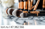 Makeup brushes arranged on a marble countertop in a beauty studio, showcasing elegance and functionality for creators and enthusiasts. Стоковое AI-изображение, AI-художник Сергей Толмачёв / Фотобанк Лори