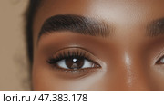 Close-up of expressive eyes with defined brows and natural skin tone in a warm light setting. Стоковое AI-изображение, AI-художник Сергей Толмачёв / Фотобанк Лори