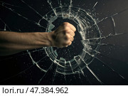 Fist forcefully breaking through glass surface, leaving a hole, dynamic energy and impact. Emphasizes strength and determination. Стоковое AI-изображение, AI-художник Коханова Наталья / Фотобанк Лори