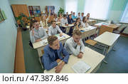 Voronovo, Belarus - January 26, 2019: Students during the lesson are sitting at their desks. Russian school. Редакционное фото, фотограф Mikhail Davidovich / Фотобанк Лори