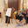 Manama, Bahrain - Jan 15 2024, An Arab woman dressed in a black burqa and niqab enthusiastically tells group of tourists about history of Islam inside of the Grand Mosque Al Fateh, Manama, Bahrain. Редакционное фото, фотограф Сергей Богомяко / Фотобанк Лори