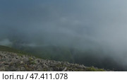 Fast moving dramatic clouds in mountains. Стоковое видео, видеограф Михаил Коханчиков / Фотобанк Лори