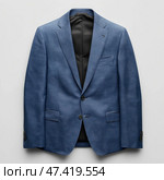 Stylish blue blazer displayed from a top-down perspective for fashion insight. Стильный синий пиджак, показанный сверху вниз для понимания моды. Стоковое AI-изображение, AI-художник Katsiaryna Repich / Фотобанк Лори