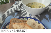 A luxurious creamy mushroom soup garnished with truffle oil  served in a white porcelain bowl. Стоковое видео, видеограф Zita Khasanova / Фотобанк Лори