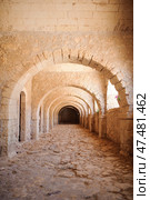 A stone corridor with a series of symmetrical arches, of a Arkadi Monastery. Стоковое фото, фотограф Artem Fomin / Фотобанк Лори