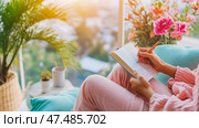 Concept: Cozy Journaling Time: Woman writing in notebook at home with sunlight, floral decor, for wellness blog or relaxation campaign. Стоковое AI-изображение, AI-художник Данила Большаков / Фотобанк Лори