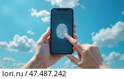 Человек разблокирует смартфон с функцией сканирования отпечатка пальца на фоне неба. Стоковое AI-изображение, AI-художник Валерий Лукин / Фотобанк Лори