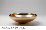 Golden minimalist metal bowl on white background. Стоковое AI-изображение, AI-художник Андрей Бакусов / Фотобанк Лори