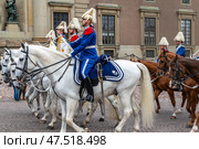 STOCKHOLM, SWEDEN - APRIL 30, 2018: Life Guards' Dragoon Music Corps on Slottsbacken street. The Royal Swedish Cavalry Band (Livgardets Dragonmusikkår). The celebration of King Carl XVI Gustaf 72 years old, at the Royal Palace in Stockholm. Редакционное фото, фотограф Сергей Комаров / Фотобанк Лори