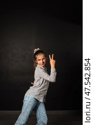 Teen Girl Posing Confidently in a Creative Setting With Expressive Gestures and Vibrant Personality. Стоковое фото, фотограф Aleksandr Golubev / Фотобанк Лори