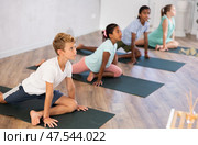 Kids yoga one legged king pigeon pose or eka rada rajakapotasana. Стоковое фото, фотограф Яков Филимонов / Фотобанк Лори