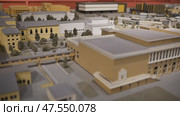 Architectural scale model showing a university campus project with buildings and trees. Стоковое видео, видеограф Mikhail Davidovich / Фотобанк Лори