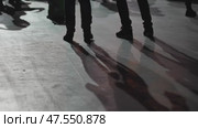 Feet and their shadows of dancing people at a concert. Стоковое видео, видеограф Mikhail Davidovich / Фотобанк Лори