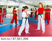 Focused kids exercising mugendo movements. Стоковое фото, фотограф Яков Филимонов / Фотобанк Лори