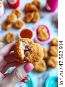 Woman holding a chicken nugget with dipping sauce. Стоковое AI-изображение, AI-художник Юрий Поздников / Фотобанк Лори