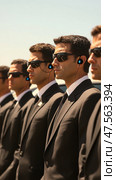 Security guards standing in line wearing suits and sunglasses. Стоковое AI-изображение, AI-художник Юрий Поздников / Фотобанк Лори