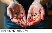 Two open hands with painted smiley faces and colorful splashes, held out against a blurred background. Concept of happiness, creativity, and positivist. Стоковое AI-изображение, AI-художник Александра Рублева / Фотобанк Лори