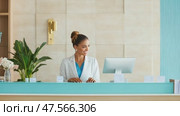 Friendly medical receptionist working at clinic reception desk. Стоковое AI-видео, аниматор Юрий Поздников / Фотобанк Лори