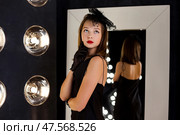 Stylish Teenage Girl Showcasing Elegance in a Sophisticated Dressing Room Atmosphere. Стоковое фото, фотограф Aleksandr Golubev / Фотобанк Лори