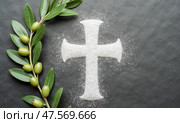 Symbolic Ash Wednesday With Ashes and Cross Surrounded by Olive Leaves on Dark Stone Background. Стоковое AI-изображение, AI-художник Sergey Grishin / Фотобанк Лори