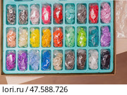 Assorted colorful plastic snap fasteners neatly arranged in rows within plastic bags, showcasing versatile clothing repair essentials. Стоковое фото, фотограф Татьяна Степанищева / Фотобанк Лори