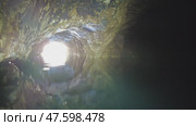 Boating on underground river in dark cave. Стоковое видео, видеограф Михаил Коханчиков / Фотобанк Лори
