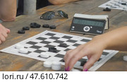 People's hand moving checkers on chess board in competition success play. Two friends playing on checkers game. Стоковое видео, видеограф Дмитрий Нечаев / Фотобанк Лори