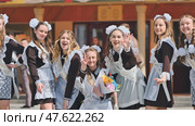 Smiling female graduates pose on the last day of school life. Стоковое фото, фотограф Mikhail Davidovich / Фотобанк Лори