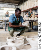 Positive man potter with mould for new ware. Стоковое фото, фотограф Яков Филимонов / Фотобанк Лори