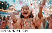 Celebration of pure joy: A little girl's exuberance under cascade of confetti and light. Стоковое AI-изображение, AI-художник Данила Большаков / Фотобанк Лори