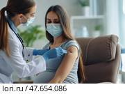 Pregnant Vaccination. Young Pregnant Woman In Face Mask Getting Vaccinated in Clinic. Doctor Giving Corona Virus Vaccine Injection to Female Patient with Belly. Covid-19 Flu Protection. Dengue fever. Стоковое AI-изображение, AI-художник Марина Демидюк / Фотобанк Лори