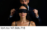 Captive connection blindfolded woman and man in dark portrait. Стоковое AI-изображение, AI-художник Андрей Бакусов / Фотобанк Лори