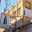 Manama, Bahrain - Jan 08 2024, panoramic view of facades of buildings with signages with inscriptions in Arabic on a narrow street, at daytime with a clear blue sky, without people, Manama, Bahrain. Редакционное фото, фотограф Сергей Богомяко / Фотобанк Лори