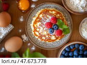 Fluffy pancakes dusted with sugar, fluffy texture enhanced by vibrant raspberries, fluffy layers promise comfort and warmth, fluffy breakfast for cozy mornings. Стоковое AI-изображение, AI-художник Мария Фадеева / Фотобанк Лори