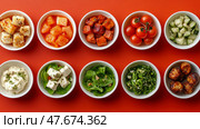 Culinary concept: A Colorful Array of Appetizers and Salad in Bowls against a Red Surface. Стоковое AI-изображение, AI-художник Данила Большаков / Фотобанк Лори