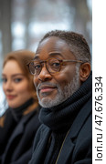 Portrait of a man with glasses and graying hair, woman in the background. Стоковое AI-изображение, AI-художник Данила Большаков / Фотобанк Лори