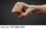 Strong fist showing determination against a dark background. Стоковое AI-видео, аниматор KATERINA AI / Фотобанк Лори