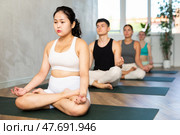 Young Asian lady performs comfortable lotus asana-Padmasana-Siddhasana pose. Стоковое фото, фотограф Яков Филимонов / Фотобанк Лори