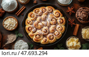 Delicious homemade cinnamon buns, baked in a round pan and generously sprinkled with powdered sugar. Around them are the baking ingredients: flour, oatmeal, cinnamon, butter, star anise and chocolate. Warm light and a wooden surface create an atmosphere of coziness and home warmth, perfectly conveying the mood of traditional cuisine and the baking process. The composition is perfect for culinary blogs, recipes, thematic publications or product advertising. Стоковое AI-изображение, AI-художник Анна Кривицкая / Фотобанк Лори
