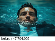 A man in a business suit lies on the surface of the water, half submerged in a pool. His face is calm, with a slight hint of reflection or inner concentration. Drops of water glisten on his skin, creating a dramatic and emotionally charged image. Ideal for themes: stress, overload, relaxation, rethinking, corporate culture, the contrast of the business environment and nature, symbolism of purification or "diving into oneself". Стоковое AI-изображение, AI-художник Анна Кривицкая / Фотобанк Лори