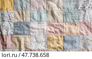 Vintage-style baby quilt in patchwork design, composed of pastel fabric pieces. Детское одеяло в винтажном стиле в стиле пэчворк, состоящее из кусочков ткани пастельных тонов. Стоковое AI-изображение, AI-художник Katsiaryna Repich / Фотобанк Лори