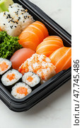 Fresh sushi bento with salmon, tuna, and rice garnished with seaweed and sesame seeds. Стоковое AI-изображение, AI-художник ФотоИнтеллект / Фотобанк Лори